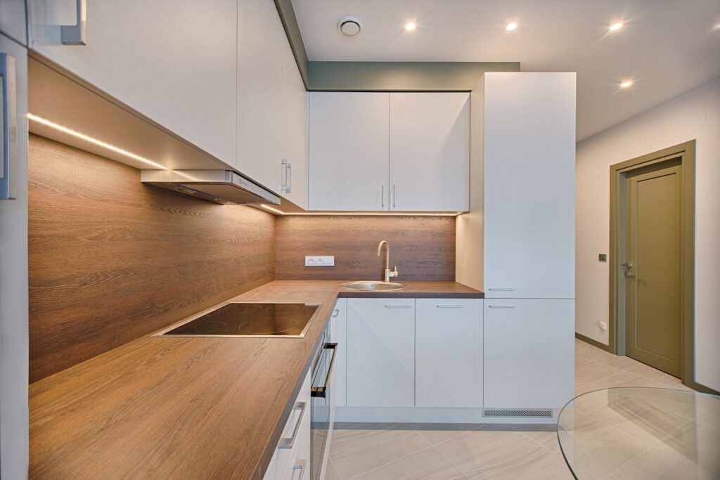 pexels-photo-1643384 Modern kitchen interior with minimalistic design and wooden accents, captured with natural lighting.